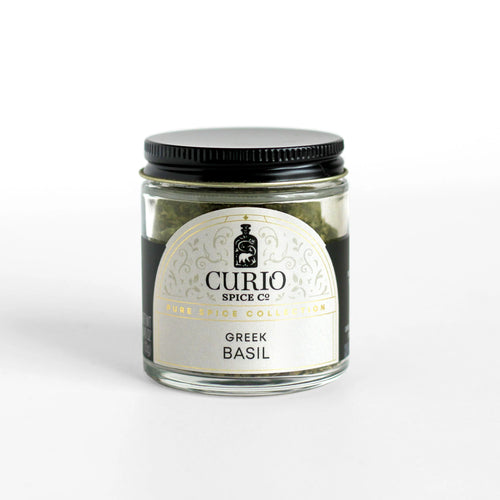 Curio Spice Co. fair-trade single origin sustainable Greek Basil in a glass jar.