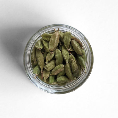 Curio Spice Co. fair-trade single origin sustainable Guatemalan green cardamom pods in a glass jar from above.