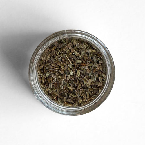 Curio Spice Co. fair-trade single origin sustainable Sicilian wild fennel seed in a glass jar from above.