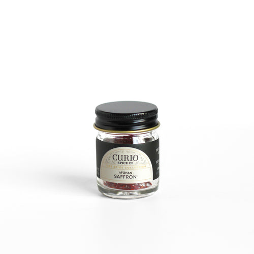 Curio Spice Co. fair-trade single origin sustainable Afghan Saffron in a glass jar.