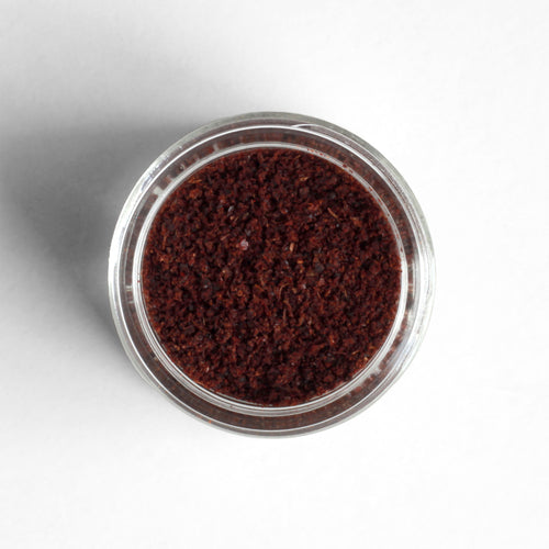 Curio Spice Co. fair-trade single origin sustainable Lebanese sumac in a glass jar from above.