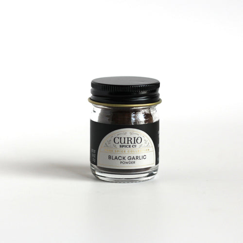 Curio Spice Co. fair-trade single origin sustainable black garlic powder in a glass jar.