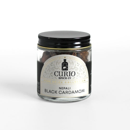 Curio Spice Co. fair-trade single origin sustainable Nepali black cardamom pods in a glass jar.