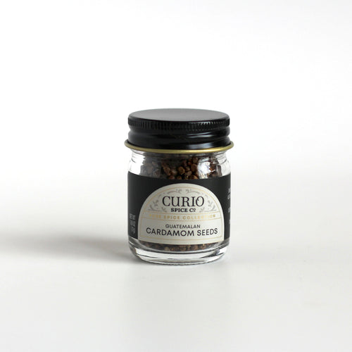 Curio Spice Co. fair-trade single origin sustainable Guatemalan green cardamom seeds in a glass jar.