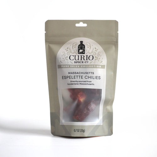 Curio Spice Co. fair-trade single origin sustainable Massachusetts whole espelette chilies in a resealable bag.