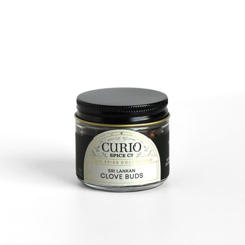 Curio Spice Co. fair-trade single origin sustainable Sri Lankan clove buds in a glass jar.