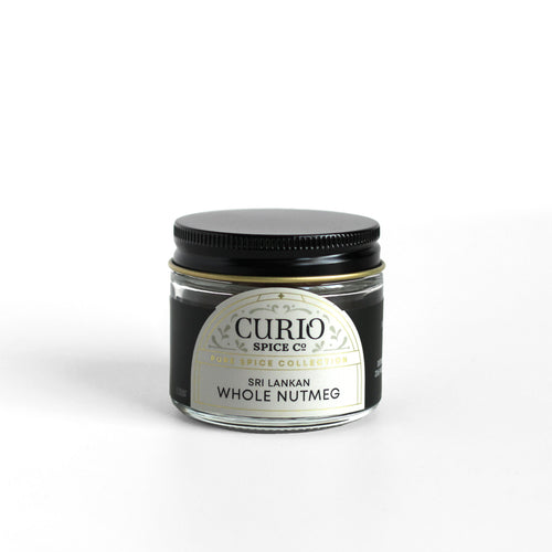 Curio Spice Co. fair-trade single origin sustainable Sri Lankan whole nutmeg in a glass jar.