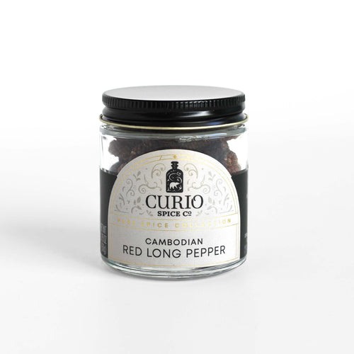 Curio Spice Co. fair-trade single origin sustainable Cambodian Red Long Pepper in a glass jar.