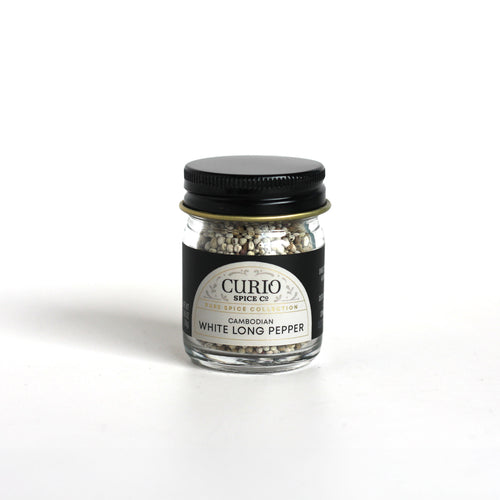 Curio Spice Co. fair-trade single origin sustainable Cambodian White Long Pepper seeds in a glass jar.