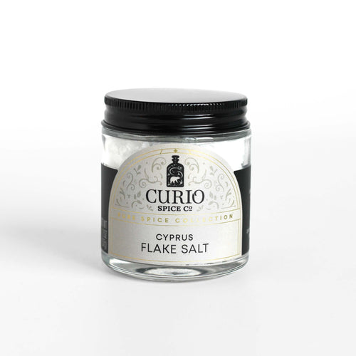 Curio Spice Co. fair-trade single origin sustainable Cyprus Flake Salt in glass jar.