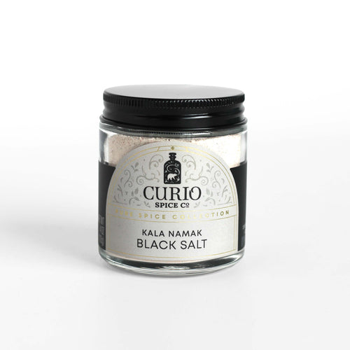 Curio Spice Co. Kala Namak Black Salt in a glass jar.