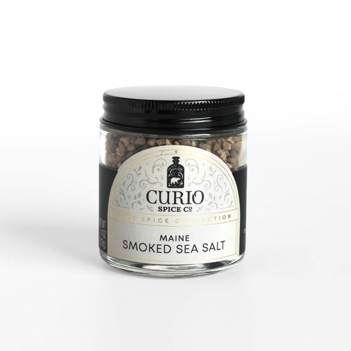 Curio Spice Co. fair-trade single origin sustainable Maine Applewood Smoked Sea Salt in a glass jar.